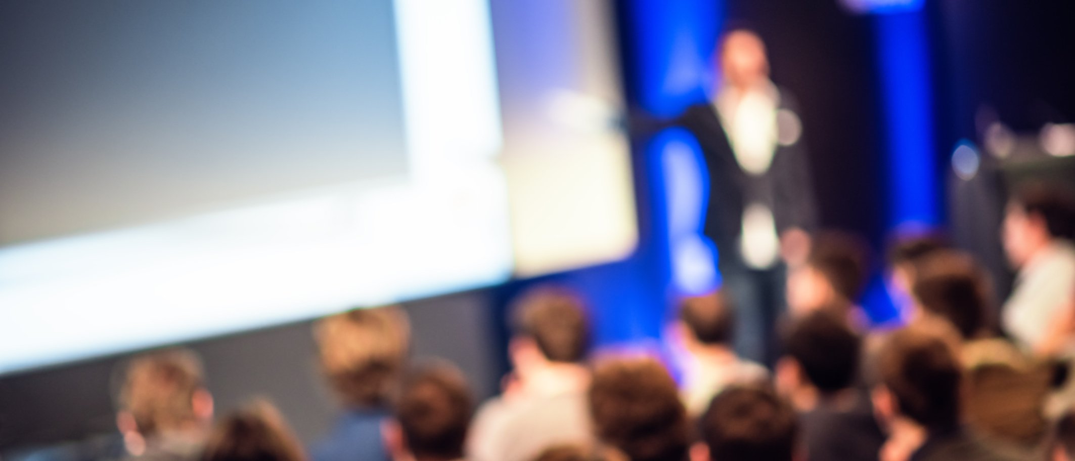 Large Group of People Listening to a Presentation